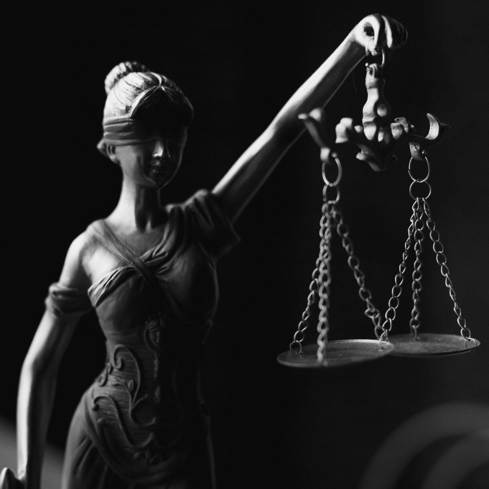 A Grayscale of a Lady Justice Figurine