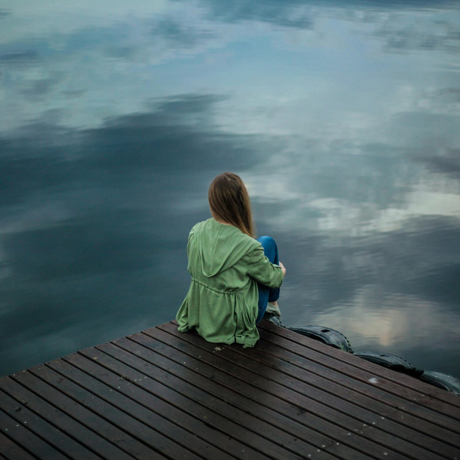 Woman Sitting on Wooden Planks